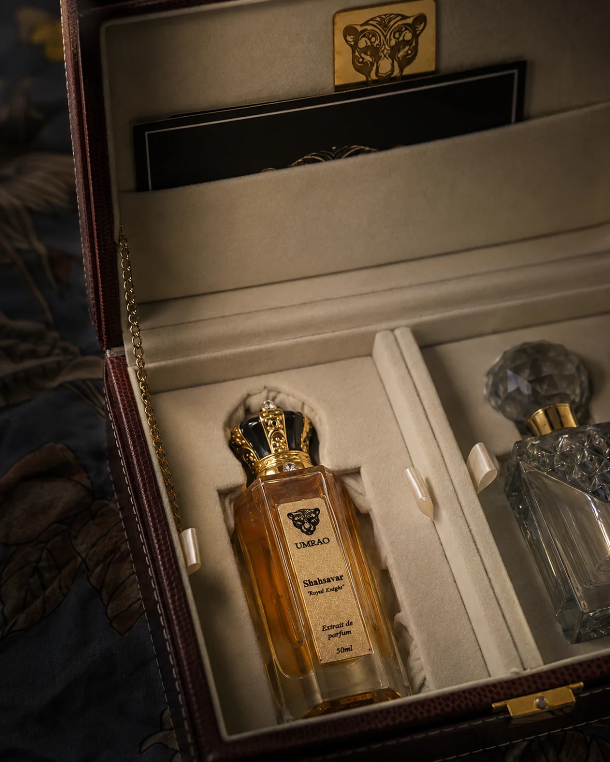 An open Umrao coffret holding Shahsavar extrait and a crystal attar decanter
